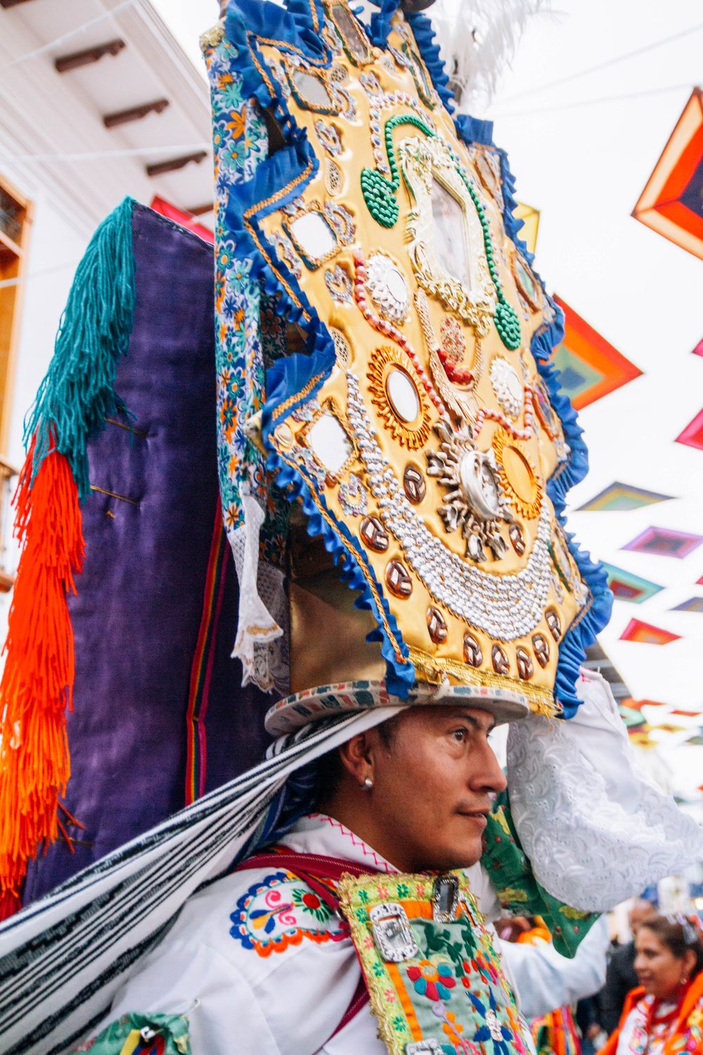 Cultural celebration in Loja, Ecuador featuring ornate traditional costume and headdress.