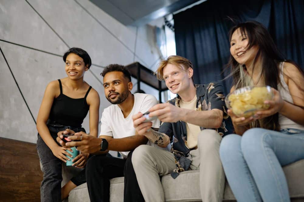A diverse group of friends having fun playing video games together indoors.