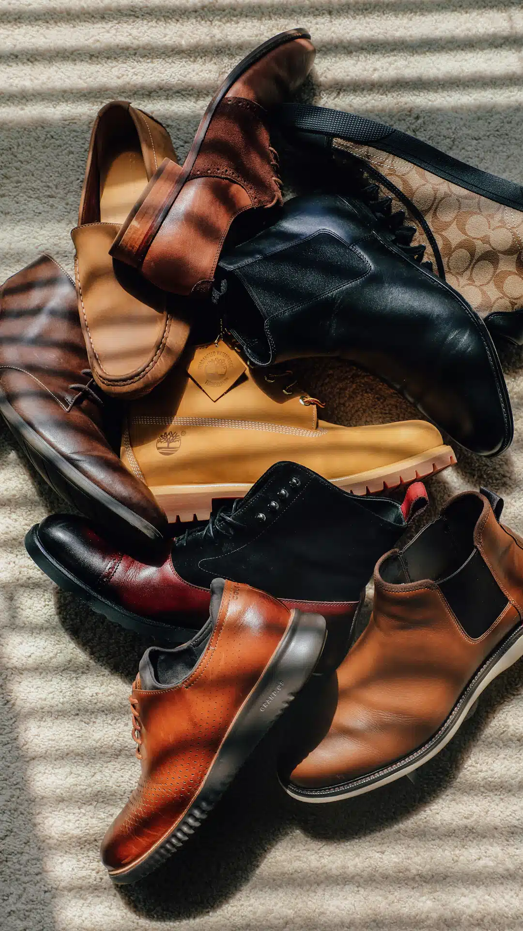 a pile of shoes sitting on top of a carpet